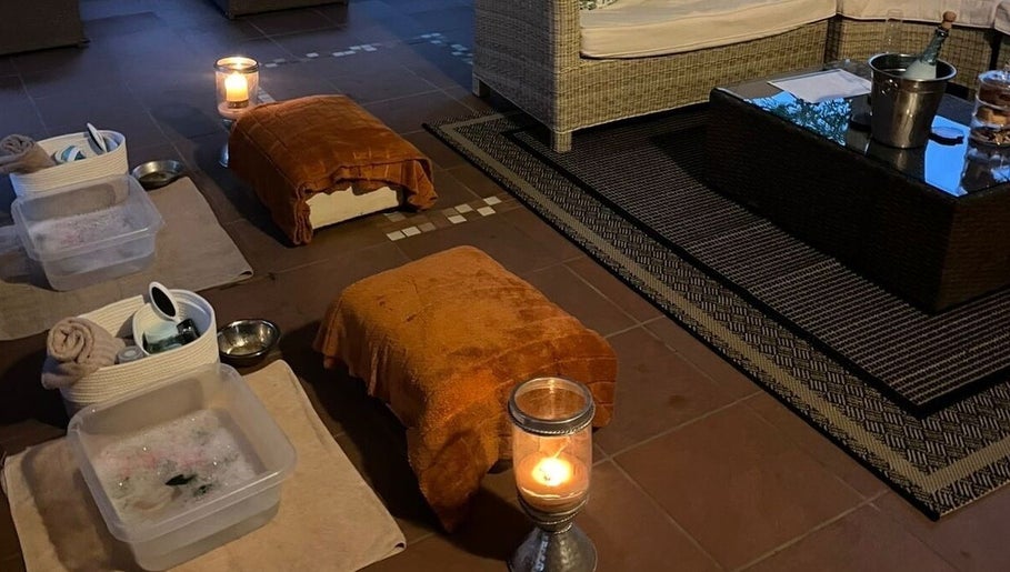 Relaxing foot soak setup at Wisani Spa, Chartwell, Gauteng, ZA, with cozy seating and ambient candles.