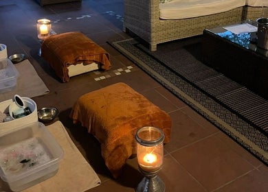 Relaxing foot soak setup at Wisani Spa, Chartwell, Gauteng, ZA, with cozy seating and ambient candles.