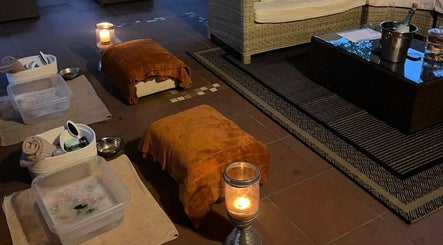 Relaxing foot soak setup at Wisani Spa, Chartwell, Gauteng, ZA, with cozy seating and ambient candles.