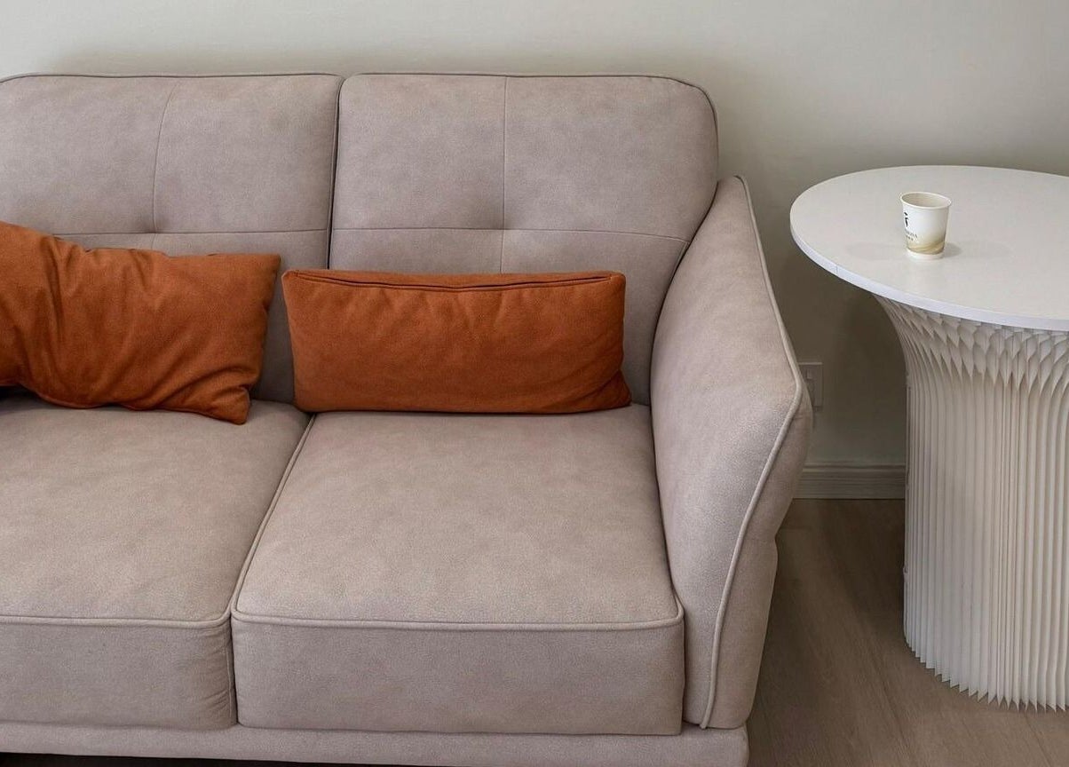 Comfortable gray sofa with orange cushions and white table at Monve Hair Design, Cheras, Kuala Lumpur, MY.