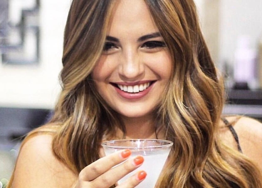 A smiling woman with wavy hair at Blond Plus Felix in Hong Kong Island, Hong Kong Island, HK.