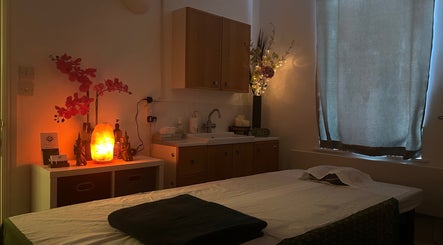 Peaceful massage room at The Lux Thai Massage, Norwich, England, GB, featuring ambient lighting and decor.