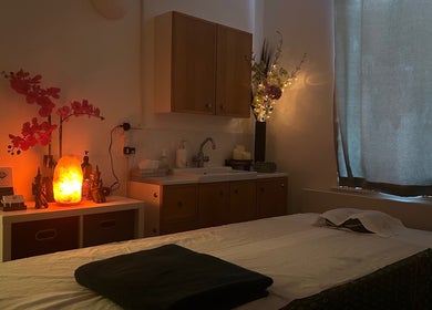 Cozy massage room at The Lux Thai Massage, Norwich, England, GB with warm lighting and elegant decor.