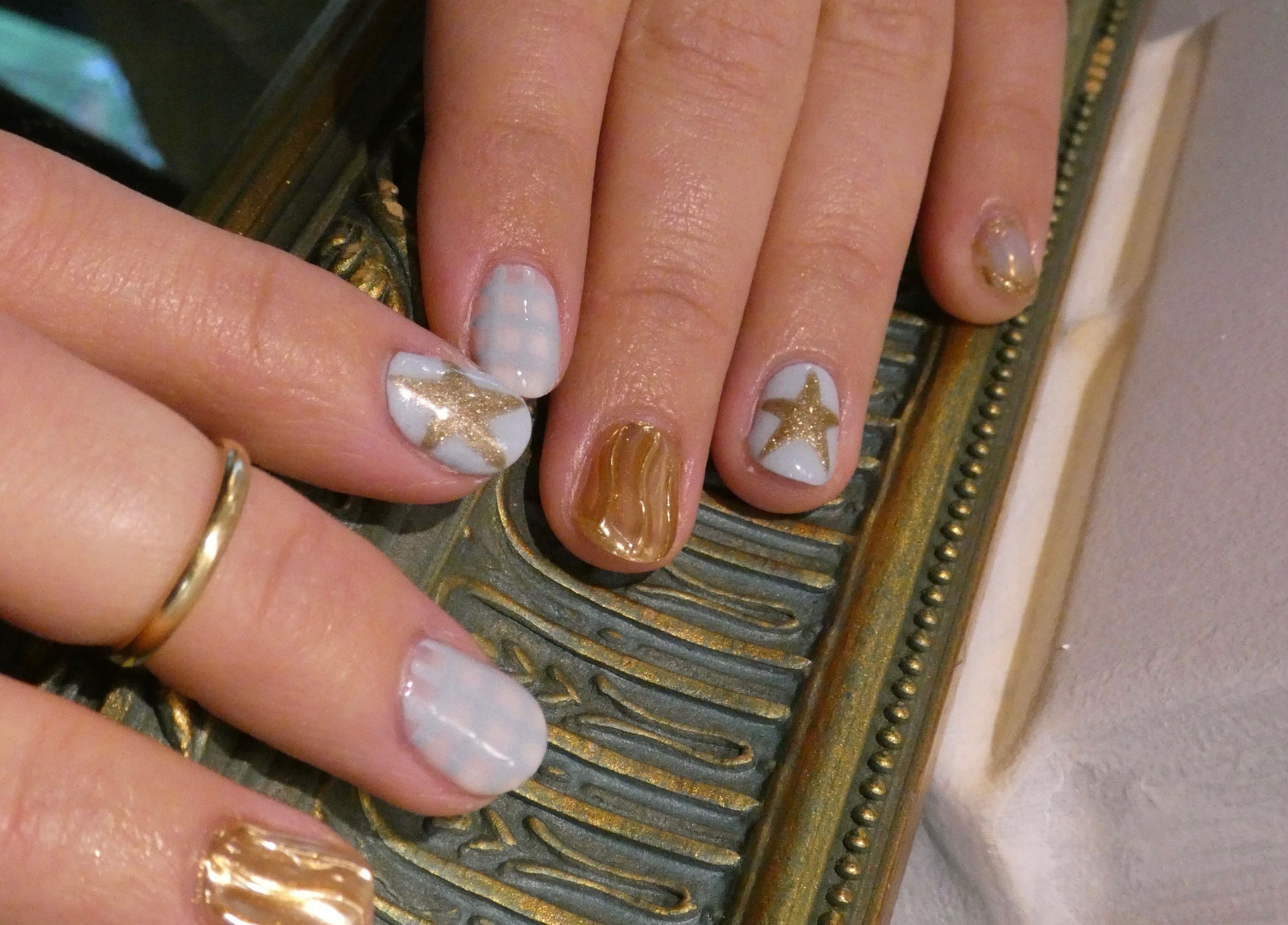Elegant star-themed nail art at Artworks96s | At Quark Hair Studio, London, England, GB.