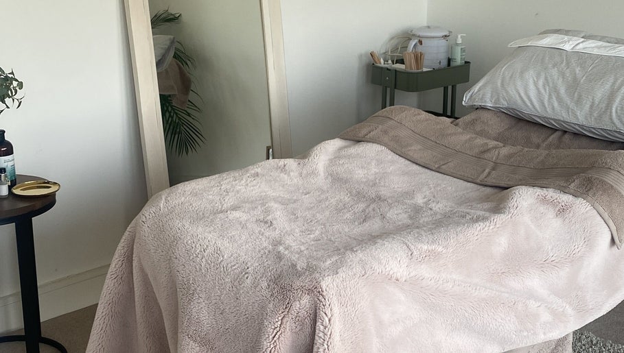 Treatment room at Body & Face, Ashford, England, GB with a plush bed and serene ambiance.
