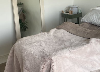 Treatment room at Body & Face, Ashford, England, GB with a plush bed and serene ambiance.