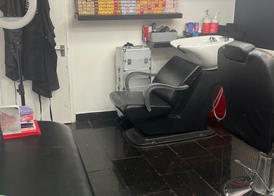 Modern interior of ANTHONY BARBER & BEAUTY SALOON in Northampton, England, GB with stylish black salon chairs.