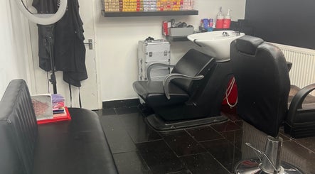 Modern interior of ANTHONY BARBER & BEAUTY SALOON in Northampton, England, GB with stylish black salon chairs.