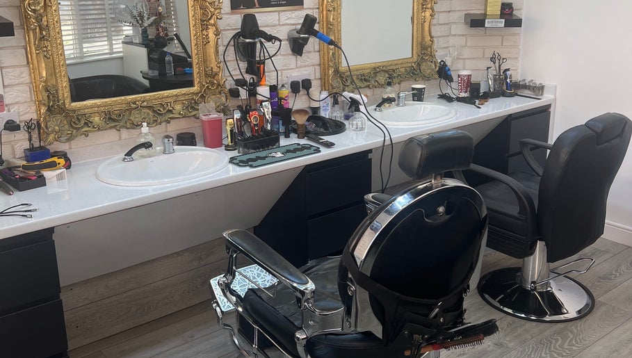Luxurious salon interior at ANTHONY BARBER & BEAUTY SALOON in Northampton, England, GB with ornate mirrors.