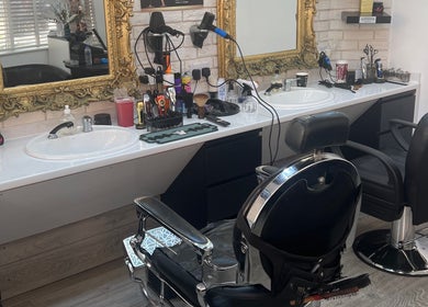 Luxurious salon interior at ANTHONY BARBER & BEAUTY SALOON in Northampton, England, GB with ornate mirrors.