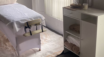 Relaxing treatment room at Alexandra, Drogheda, County Louth, IE, featuring a massage table and soft lighting.