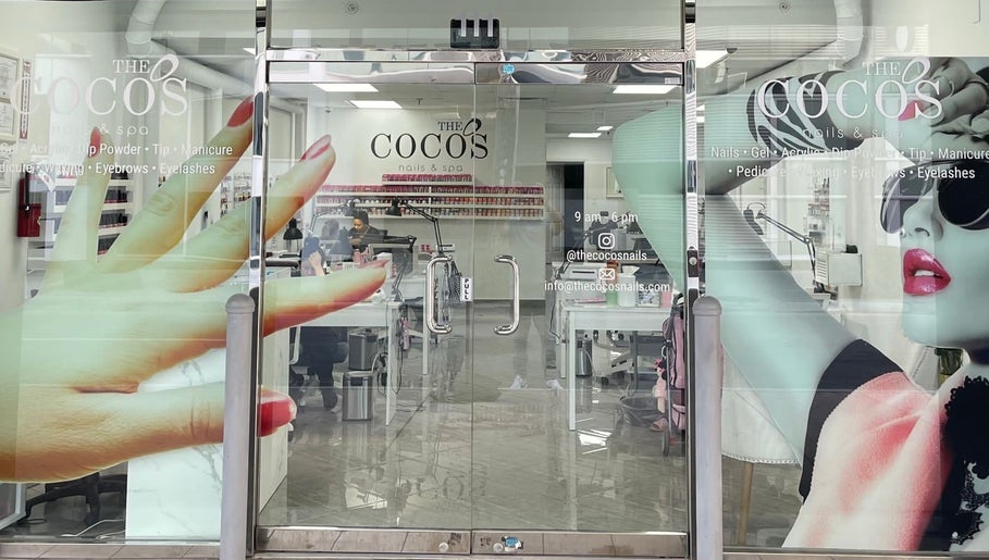 Entrance of The Coco's Nail & Spa in Miami, Florida, US with vivid nail art decor on the glass door.