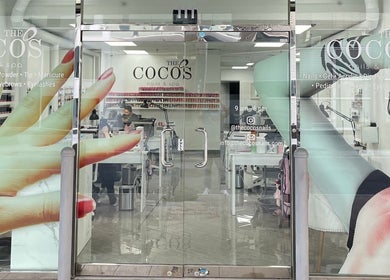 Entrance of The Coco's Nail & Spa in Miami, Florida, US with vivid nail art decor on the glass door.