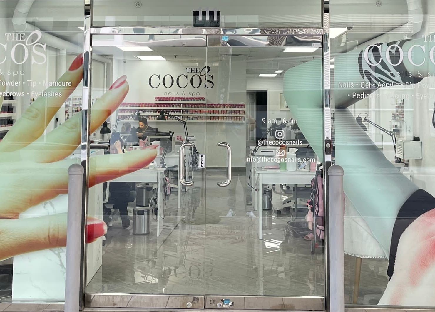 Entrance of The Coco's Nail & Spa in Miami, Florida, US with vivid nail art decor on the glass door.
