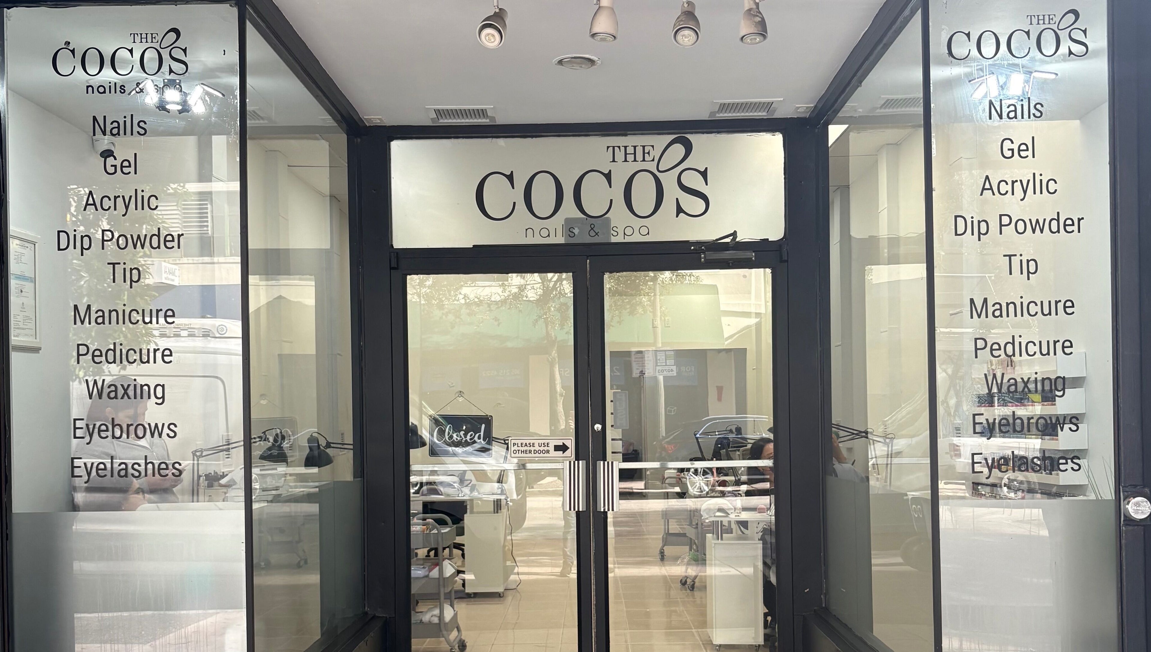 Entrance of The Coco's Nail & Spa in Miami, Florida, US offering nails, waxing, and eyelashes services.