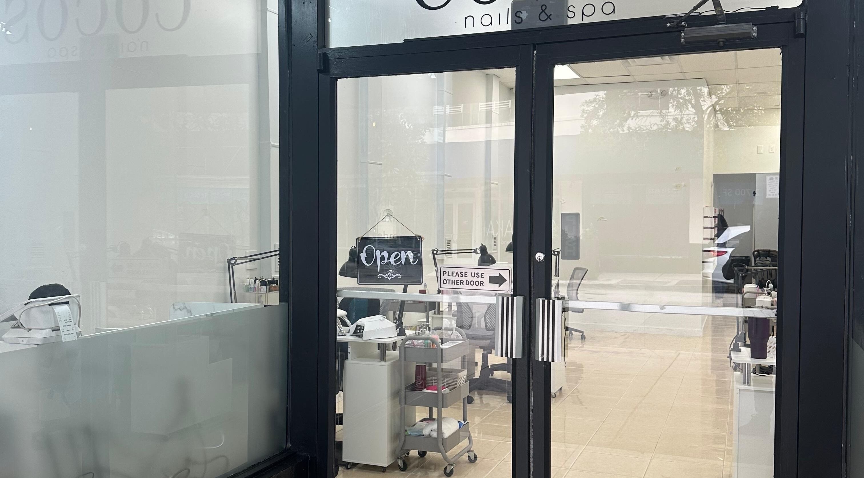 Entrance of The Coco's Nail & Spa in Miami, Florida, US showcasing inviting decor and open sign.
