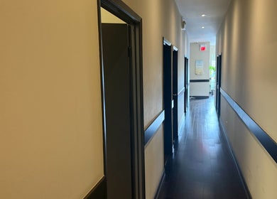 Quiet hallway at Midland Health Center, Toronto, Ontario, CA, leading to wellness treatment rooms.
