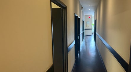 Quiet hallway at Midland Health Center, Toronto, Ontario, CA, leading to wellness treatment rooms.