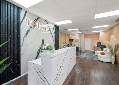 Elegant interior of Lullea Nails Shop, Toronto, Ontario, CA with marble accents and cozy seating.