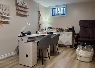 Inviting interior of Lullea Nails Shop in Toronto, Ontario, CA with elegant nail stations and a plush pedicure chair.