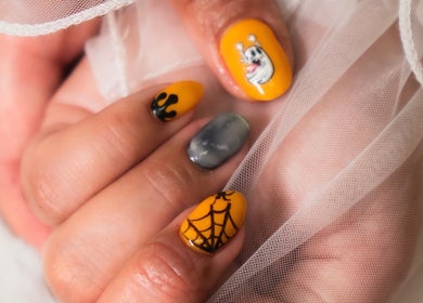 Festive Halloween nail art at Lullea Nails Shop in Toronto, Ontario, CA featuring ghost and spiderweb designs.