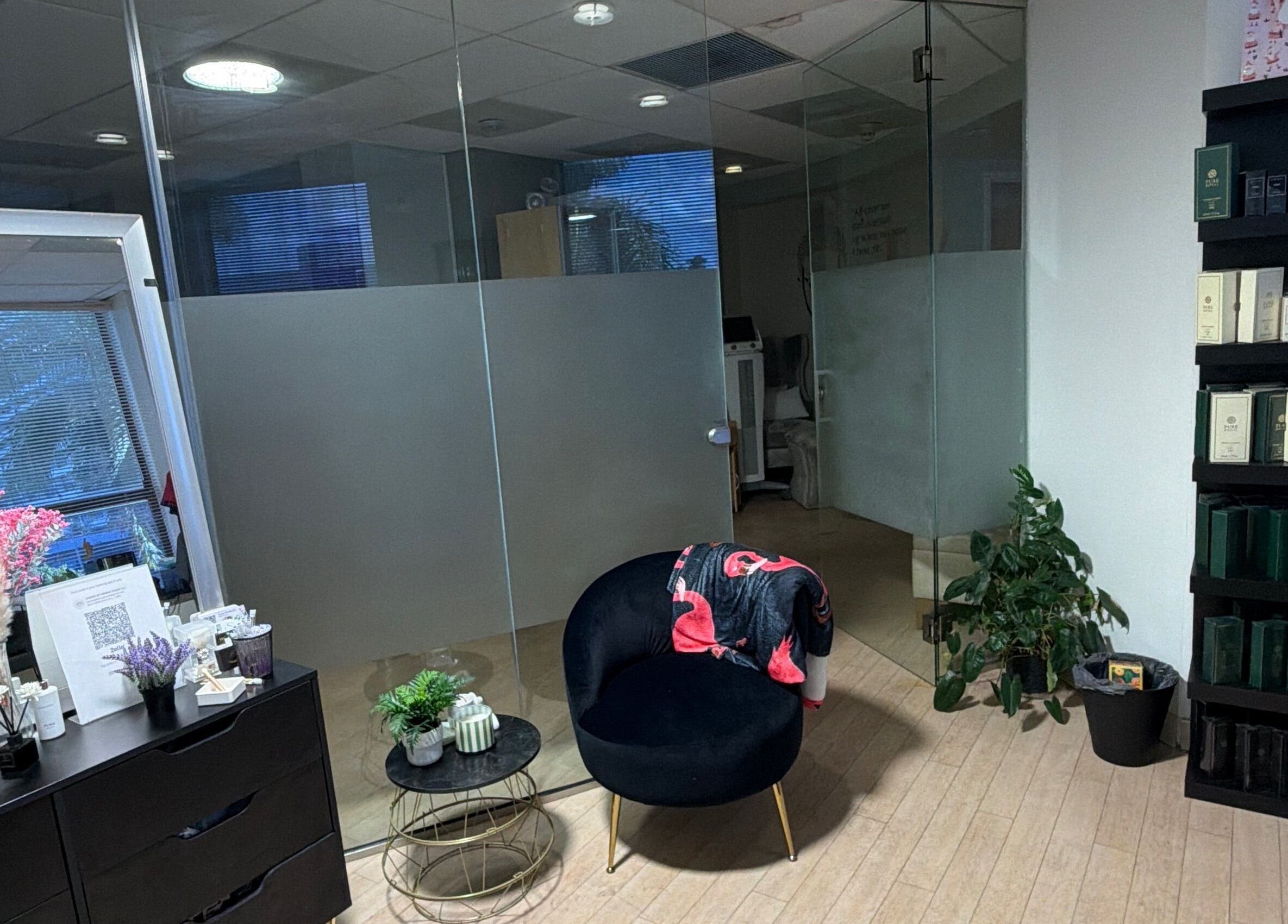 Chic lounge area at UNOVA lashes by HK in Hallandale Beach, Florida, US with stylish decor and seating.