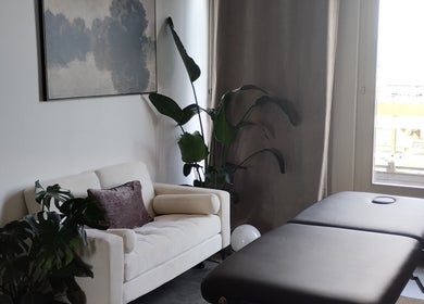 Salle de massage élégante à l'ART institut, Genève, Genève, CH avec canapé et table massage.
