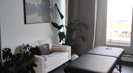 Salle de massage élégante à l'ART institut, Genève, Genève, CH avec canapé et table massage.