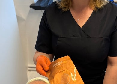 Beautician at Sweet Epil Beauty in London offers a Vitamin C face mask treatment to enhance skin radiance.