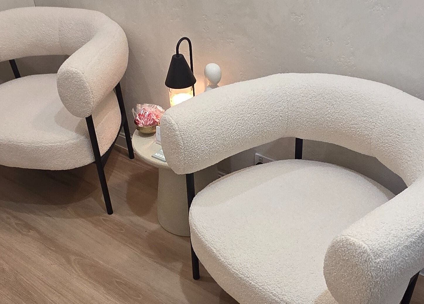 Two elegant cream chairs and a lamp in a serene setting at Ease & Elevate, Burleigh Heads, QLD, AU.