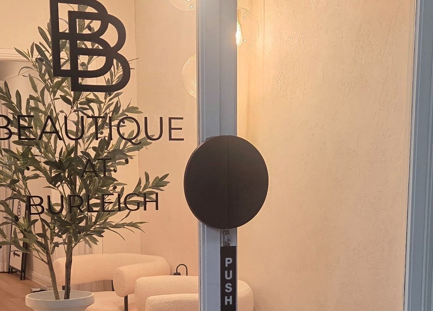 Inviting entrance of Ease & Elevate in Burleigh Heads, QLD, AU, showcasing minimalist design and lush greenery.