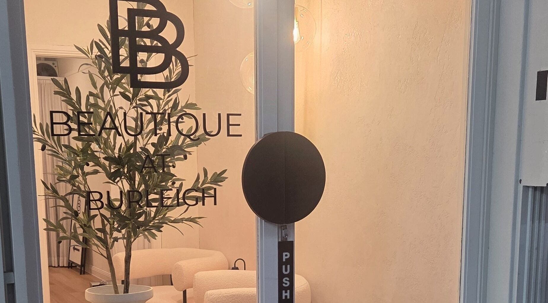 Inviting entrance of Ease & Elevate in Burleigh Heads, QLD, AU, showcasing minimalist design and lush greenery.