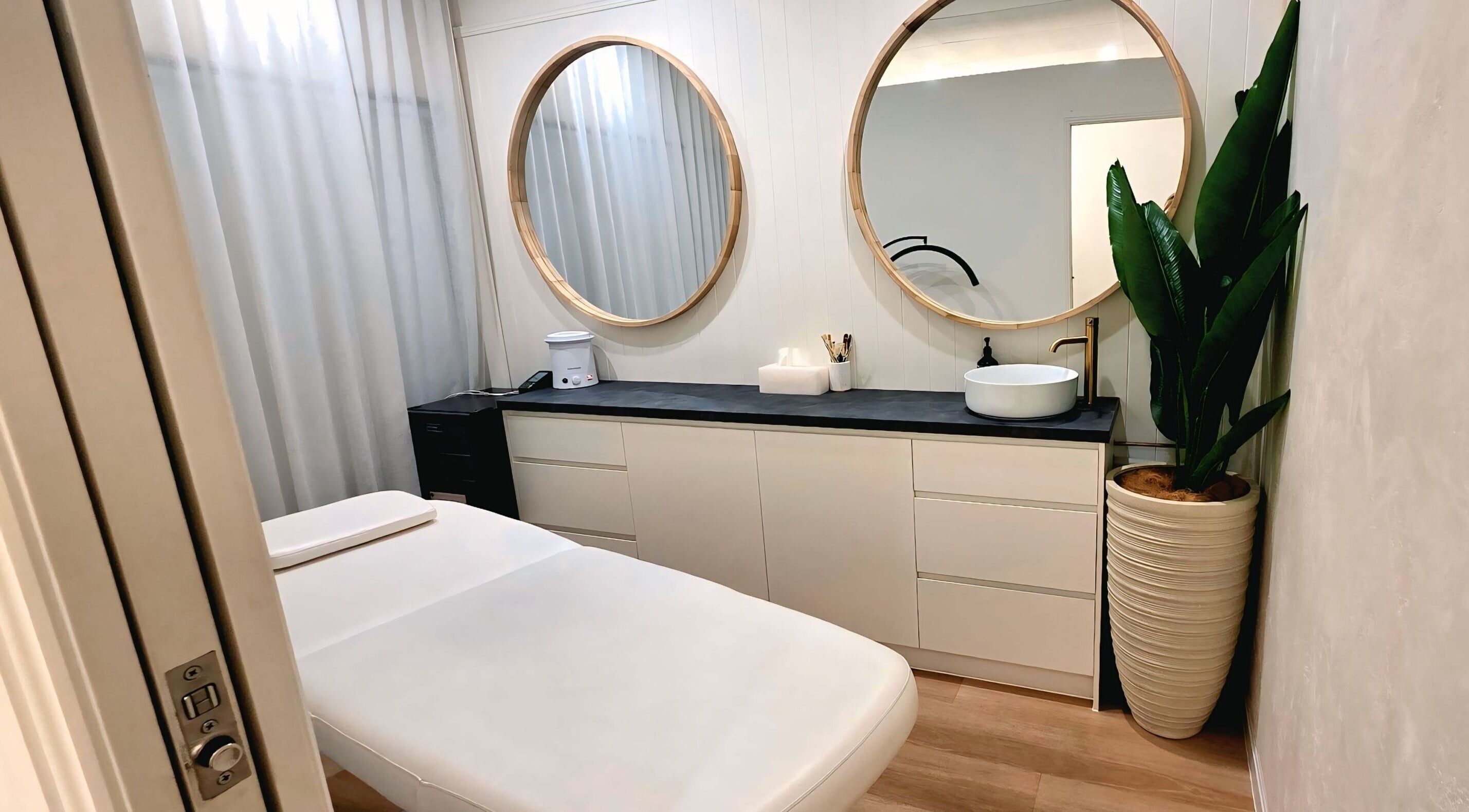 Serene treatment room at Ease & Elevate, Burleigh Heads, QLD, AU with cozy bed and elegant mirrors.