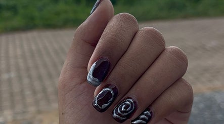 Close-up of a hand with swirl nail art at Lexcie_nails, Paramaribo, Paramaribo District, SR.