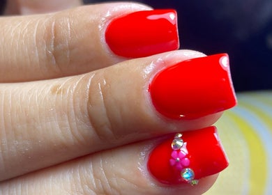 Vibrant red nail art with rhinestones at Carmen Sanchez Nail Art, Atlixco, Puebla, MX.