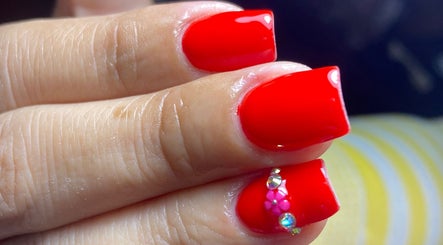 Vibrant red nail art with rhinestones at Carmen Sanchez Nail Art, Atlixco, Puebla, MX.