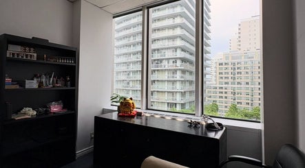 Modern office at Beca’s Beauty Spectrum in Toronto, Ontario, CA with cityscape view through large windows.