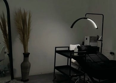Elegant beauty treatment room at Lashology.anna in Melbourne, Victoria, AU with bed and minimalist decor.