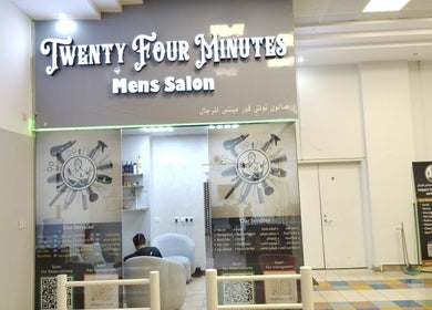 Front view of 24 minutes men's salon in Abu Dhabi, AE, featuring stylish branding and modern decor.