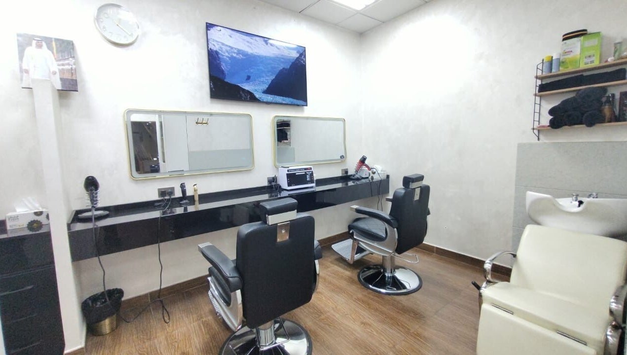 Modern salon interior at 24 minutes, Abu Dhabi, AE featuring sleek black chairs and mirrors.