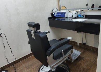 Modern black salon chair and counter at 24 minutes, Abu Dhabi, Abu Dhabi, AE, showcasing elegance.