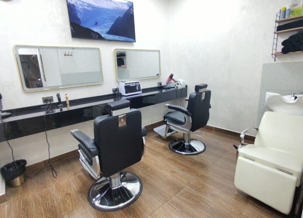 Spacious salon interior at 24 minutes in Abu Dhabi, AE featuring modern styling chairs and wash station.