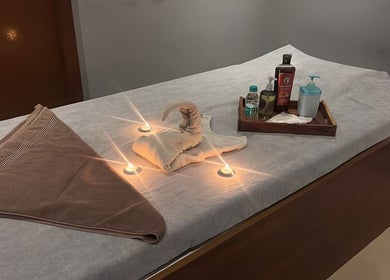 Massage table set with towels and oils at The Follicle Salon Spa, Bhovi Palya, Bengaluru, Karnataka, IN.