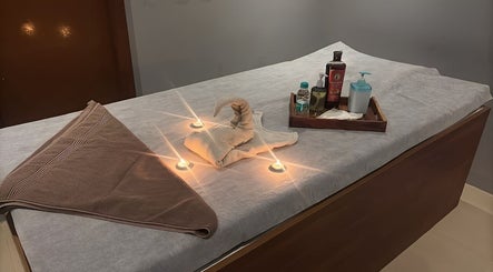 Massage table set with towels and oils at The Follicle Salon Spa, Bhovi Palya, Bengaluru, Karnataka, IN.