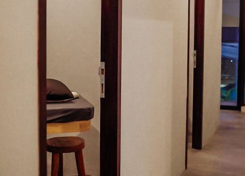 Private massage room at Body Wonders SPA & Massage, Bali, Bali, ID with a cushioned bed and warm lighting.