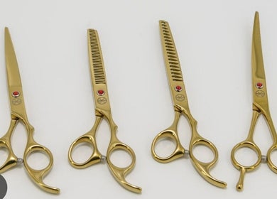 Four gold grooming scissors from Luna pets, Gloucester, England, GB, showcasing premium pet care tools.