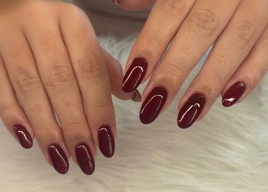 Elegant burgundy nails at Nails and Beauty by Chlo, Llanelli, Wales, GB showcasing delicate nail art.