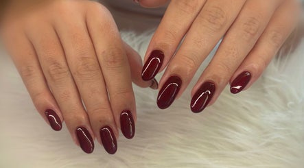 Elegant burgundy nails at Nails and Beauty by Chlo, Llanelli, Wales, GB showcasing delicate nail art.