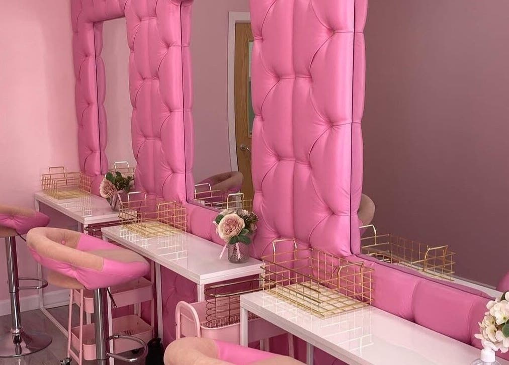 Chic, pink beauty setup at Liberty Autumn Aesthetics in Southampton, England, GB, featuring plush seating and mirrors.