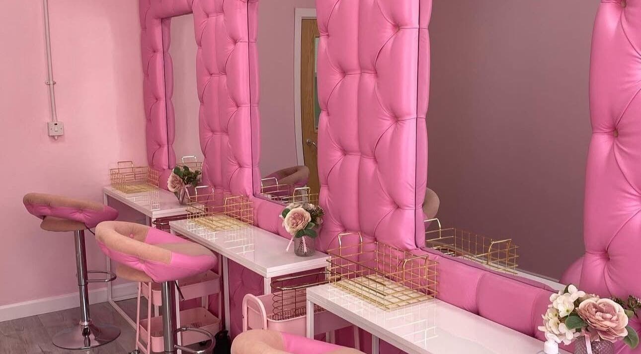 Chic, pink beauty setup at Liberty Autumn Aesthetics in Southampton, England, GB, featuring plush seating and mirrors.